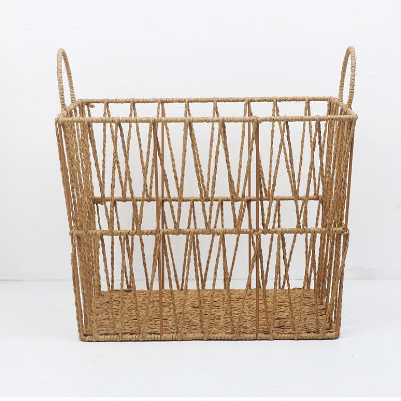 Front view of rectangular rattan storage basket on white background, open lattice sides and loop handles.