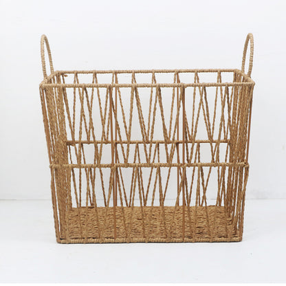 Front view of rectangular rattan storage basket on white background, open lattice sides and loop handles.