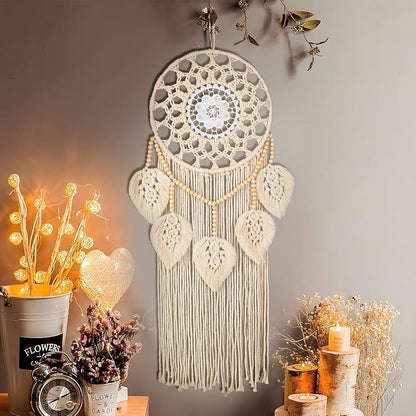 Boho handwoven round leaf macrame tapestry hanging in a cozy room with candles and warm lighting.