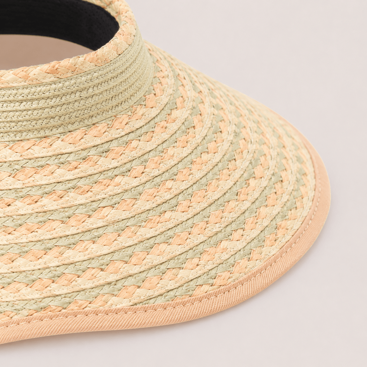 Close-up of the braided paper straw texture and bound brim edge on a green khaki sun visor