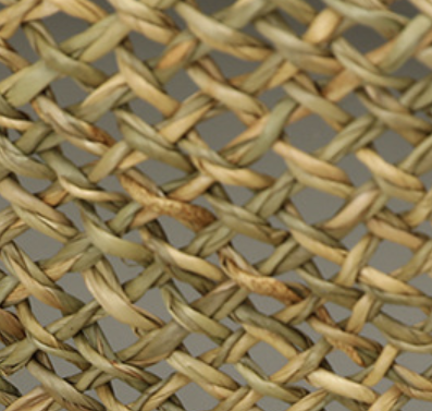 Close-up detail of natural flax straw weave pattern showing artisanal texture and interlaced craftsmanship.