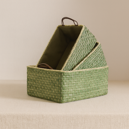 Set of three stackable green straw baskets nested together to show space-saving storage design.