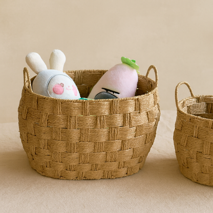Straw basket used for toy storage with plush bunny and carrot dolls inside, home decor scene.