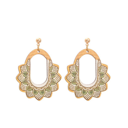 Wooden earrings with floral mandala pattern in green and beige tones, hanging on gold studs.