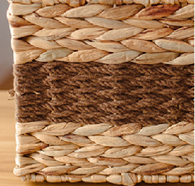 Close-up of the brown woven stripe design on the side of the gourd grass storage basket.
