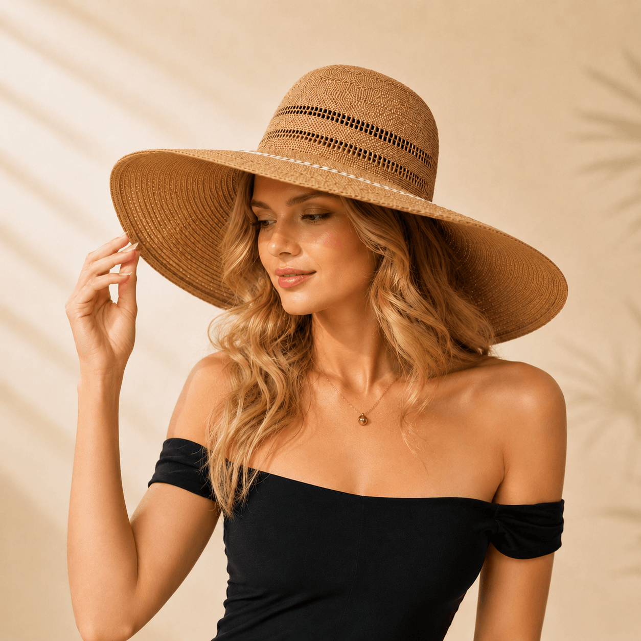 Woman wearing a handwoven openwork wide brim paper straw sun hat in khaki with a black off-shoulder top