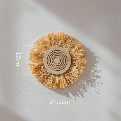 Small round raffia straw wall decor piece with concentric circles, measuring 24.5 cm wide and 12 cm deep.