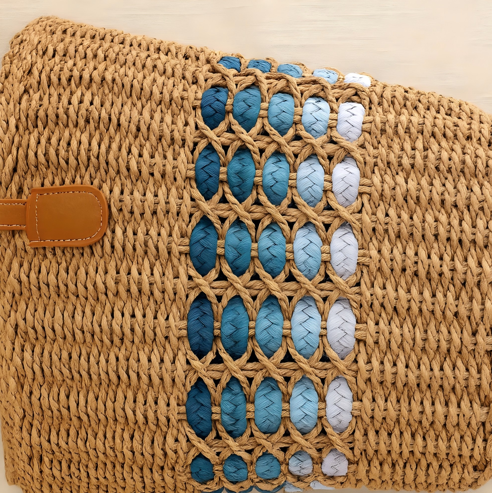 Close-up of the brown straw tote showing the intricate blue gradient band weaving detail in a horizontal pattern.