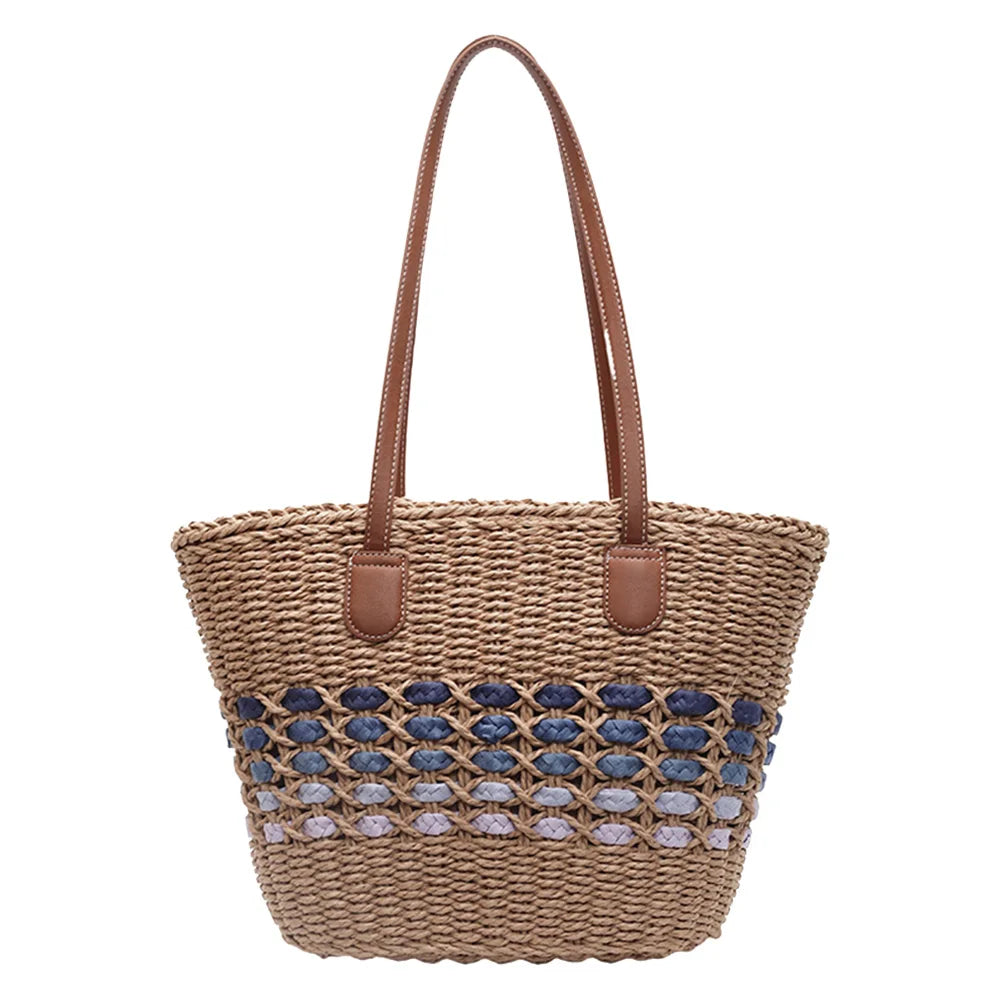 Studio shot of the brown handwoven straw tote with blue gradient band and brown leather handles on a white background.