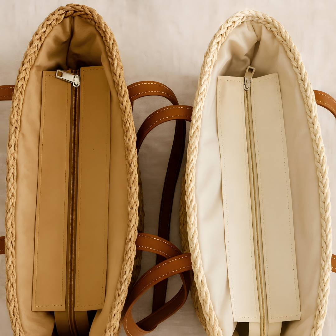 Top view of two handwoven straw totes showing inner zip closures and fabric linings in beige and cream tones.