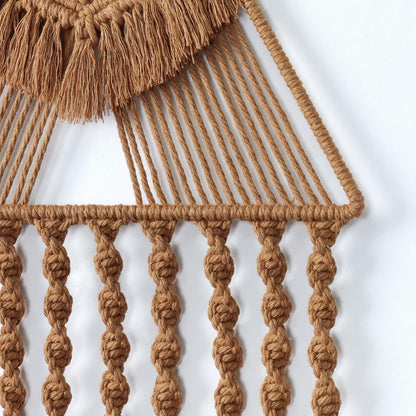 Close-up of handwoven macrame detailing showing twisted rope texture and tassel craftsmanship.