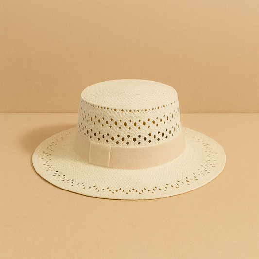 Ivory straw hat with openwork weave pattern and beige fabric band, displayed on beige background for a soft natural tone.