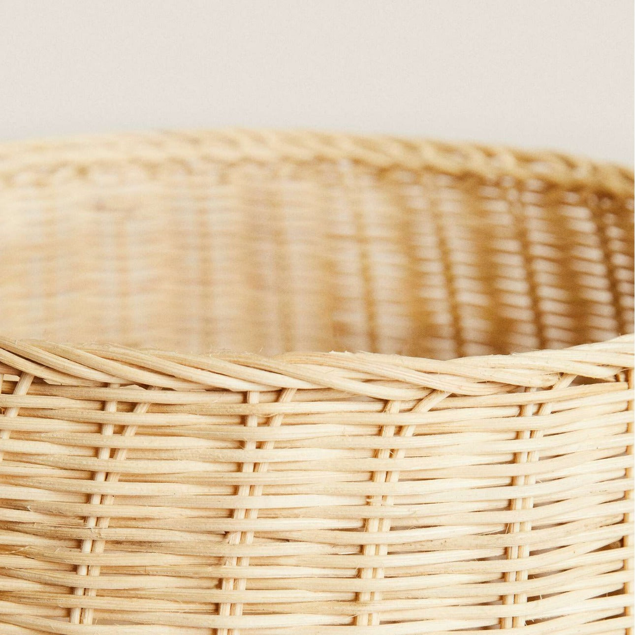 Detail view of reinforced rim and side wall showcasing smooth braided edge and dense weaving.