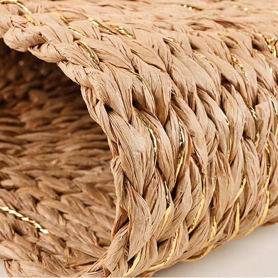 Close-up of the straw material with subtle golden threads woven throughout for a touch of shimmer and texture.