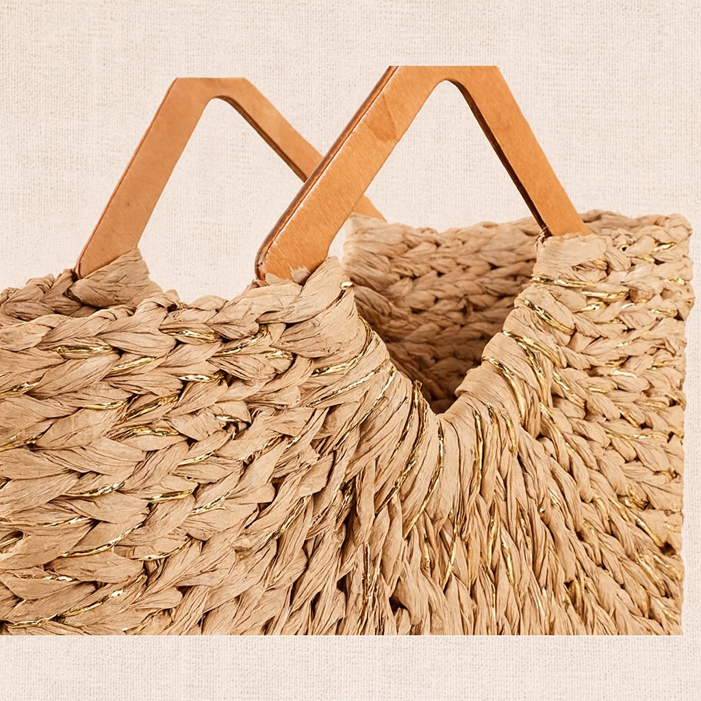 Close-up of the wooden handles of the straw tote bag, highlighting their smooth geometric shape and the tight straw weaving.