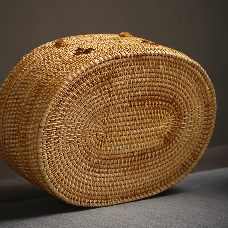 Bottom view of oval handmade rattan storage box highlighting the detailed weaving pattern and smooth craftsmanship.