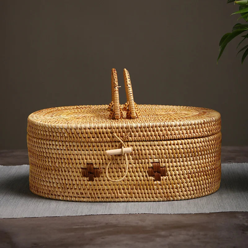 Front view of large handmade rattan storage box with dual handle and loop latch, set against neutral background.