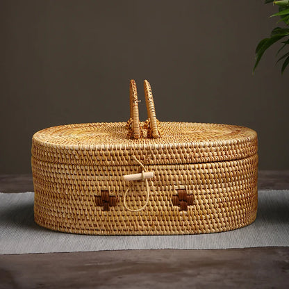 Front view of large handmade rattan storage box with dual handle and loop latch, set against neutral background.