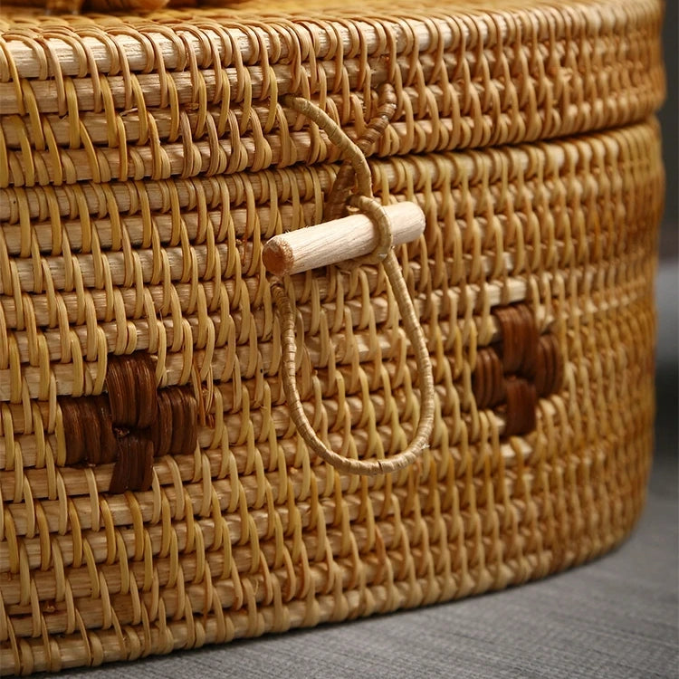 Close-up of the handmade rattan storage box latch with natural wooden toggle and loop closure.