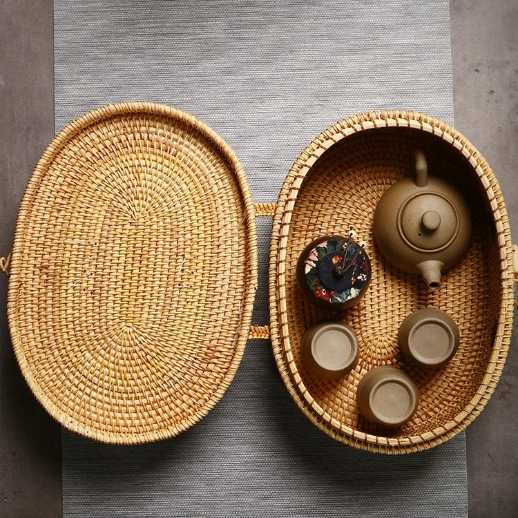 Top-down view of open rattan box filled with a teapot and cups, showing spacious interior design.