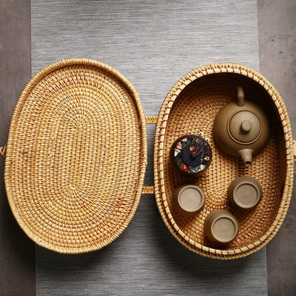 Top-down view of open rattan box filled with a teapot and cups, showing spacious interior design.