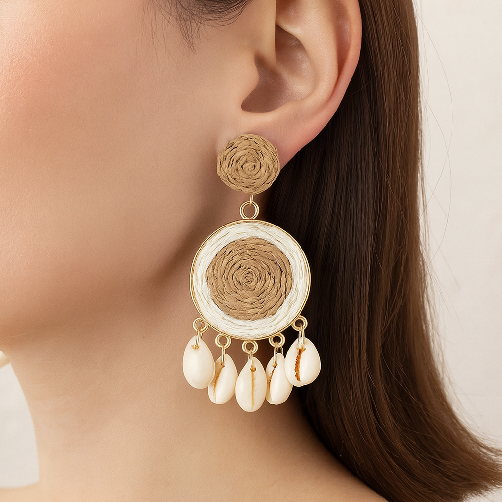 Close-up of raffia-woven shell earring with circular design worn by woman in natural light.