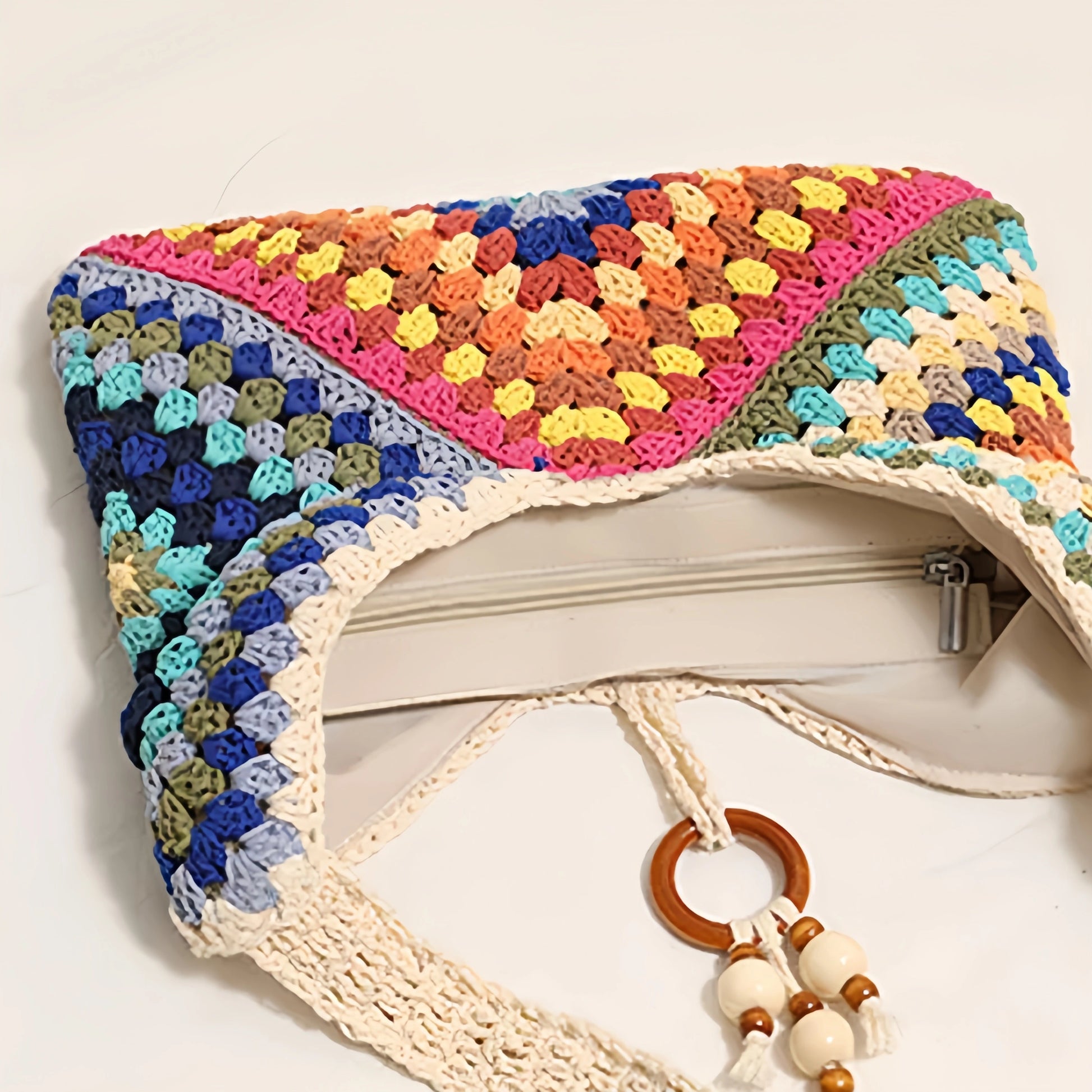 Top view of the multicolor woven shoulder bag showing the zipper closure and soft cotton lining.