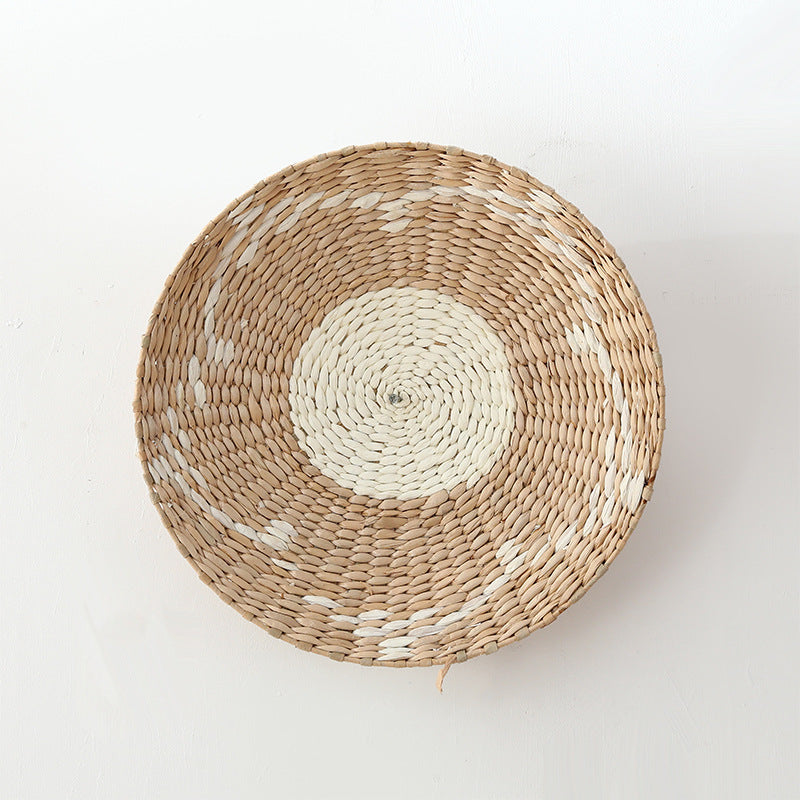Minimalist natural fiber woven wall plate with concentric beige and white circles, handcrafted texture.
