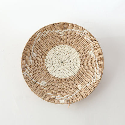 Minimalist natural fiber woven wall plate with concentric beige and white circles, handcrafted texture.