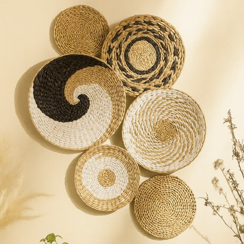 Set of seven handwoven natural fiber wall plates arranged in geometric patterns, showcasing bohemian organic style.