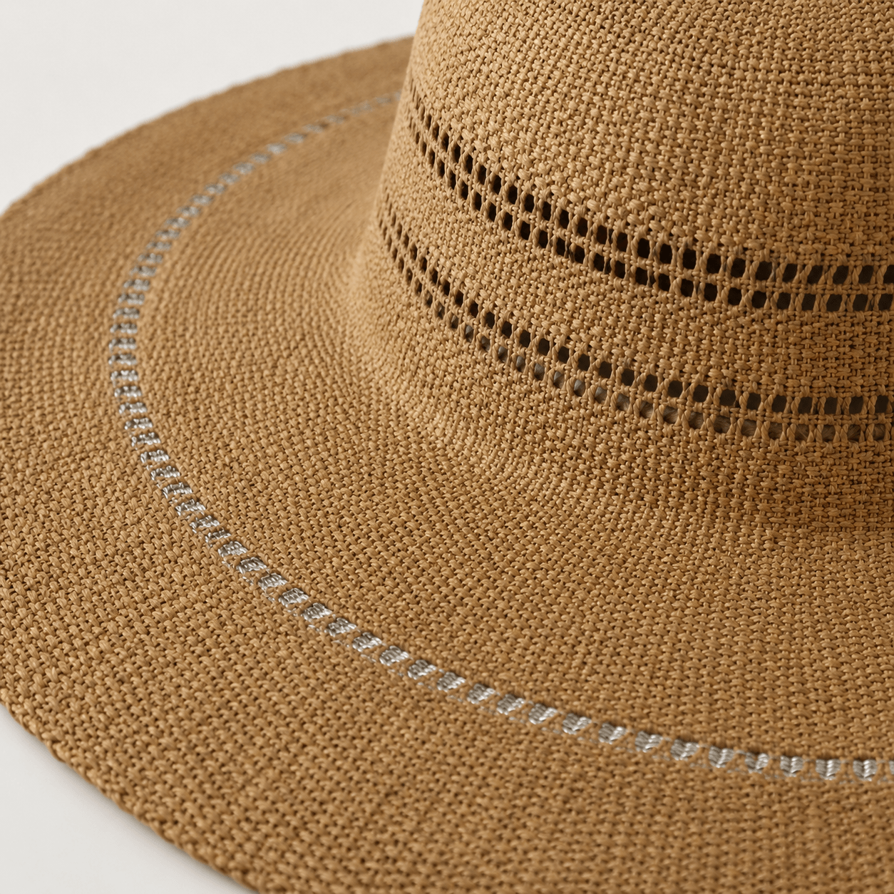 Close-up of the handwoven paper straw texture, openwork crown bands, and contrast brim stitching