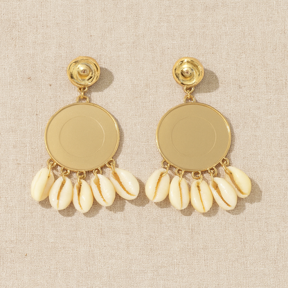 Back view of gold-tone shell earrings showing smooth metallic base and shell drops.