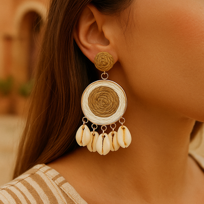 Raffia-woven shell earring with natural color design worn outdoors in warm lighting.