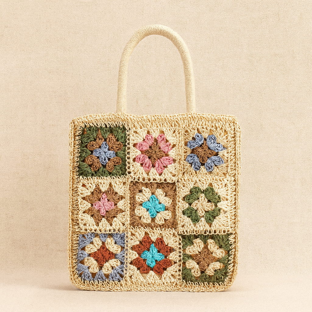 “Front close-up of light straw crochet shoulder bag featuring multicolor floral embroidery, by Solmerea.”