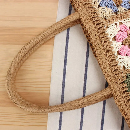 “Close-up of woven straw handle of embroidered shoulder bag showing hand-braided craftsmanship, by Solmerea.”