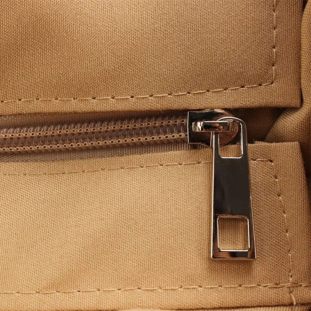“Close-up of inner zipper pocket with metal pull tab inside embroidered straw shoulder bag, by Solmerea.”