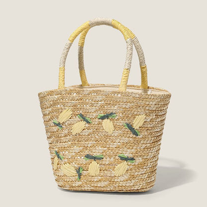“Lemon-embroidered straw tote with cream and yellow handles on neutral background, by Solmerea.”
