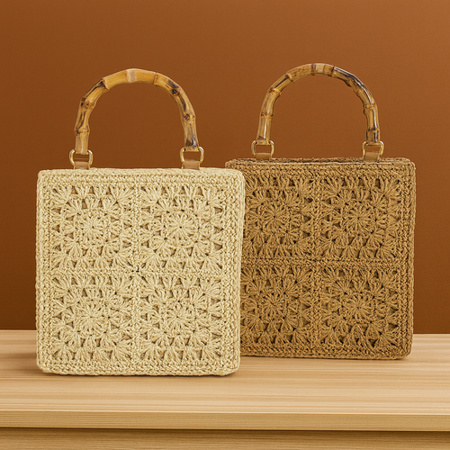 “Set of two square handwoven straw handbags with bamboo handles in beige and brown, by Solmerea.”