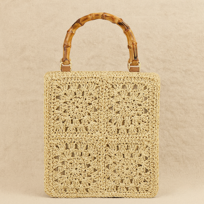 “Beige square straw handbag with bamboo handle and floral crochet weave, minimalist studio shot, by Solmerea.”