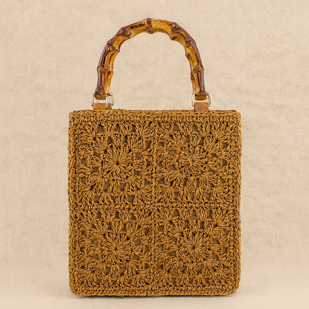 “Brown crochet-patterned straw handbag with bamboo handle, handcrafted texture detail, by Solmerea.”