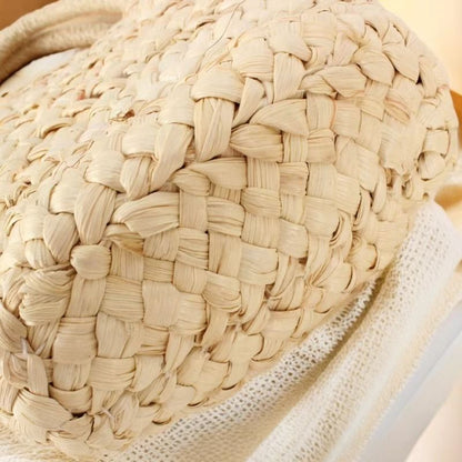 “Close-up of the bottom weaving pattern of handwoven corn husk handbag showing tight braid texture, by Solmerea.”
