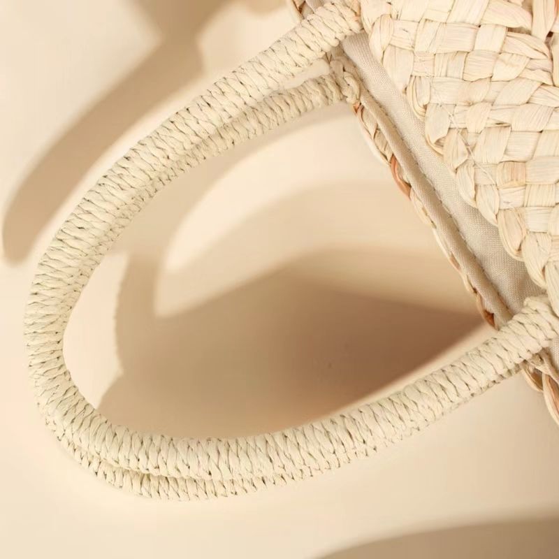 “Close-up of handwoven corn husk handbag handle showing braided craftsmanship and texture, by Solmerea.”