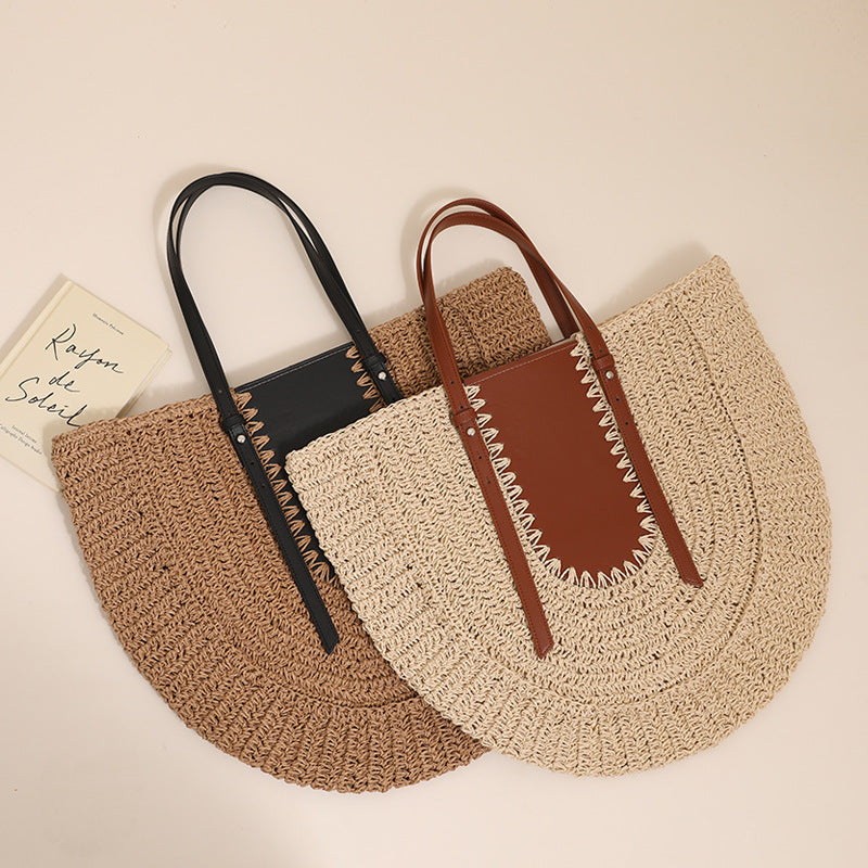“Flatlay of two semicircular straw clutch bags in beige and brown with leather accents, by Solmerea.”