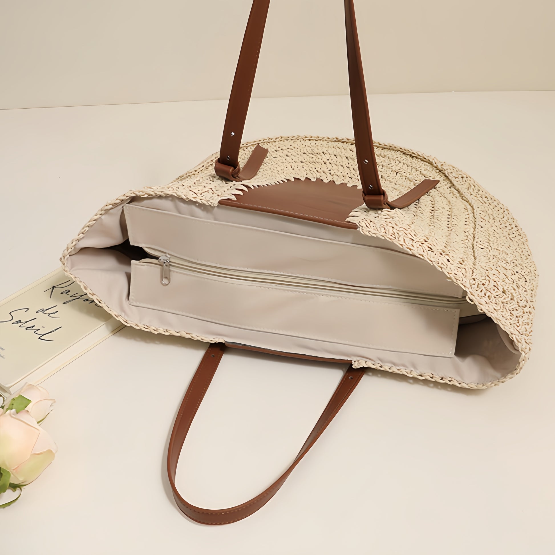 “Top view of beige straw clutch showing internal zipper pocket and neat lining, by Solmerea.”