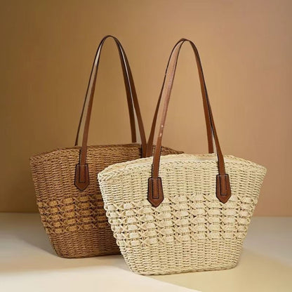 Set of two woven straw shoulder totes in beige and brown with leather straps, by Solmerea.