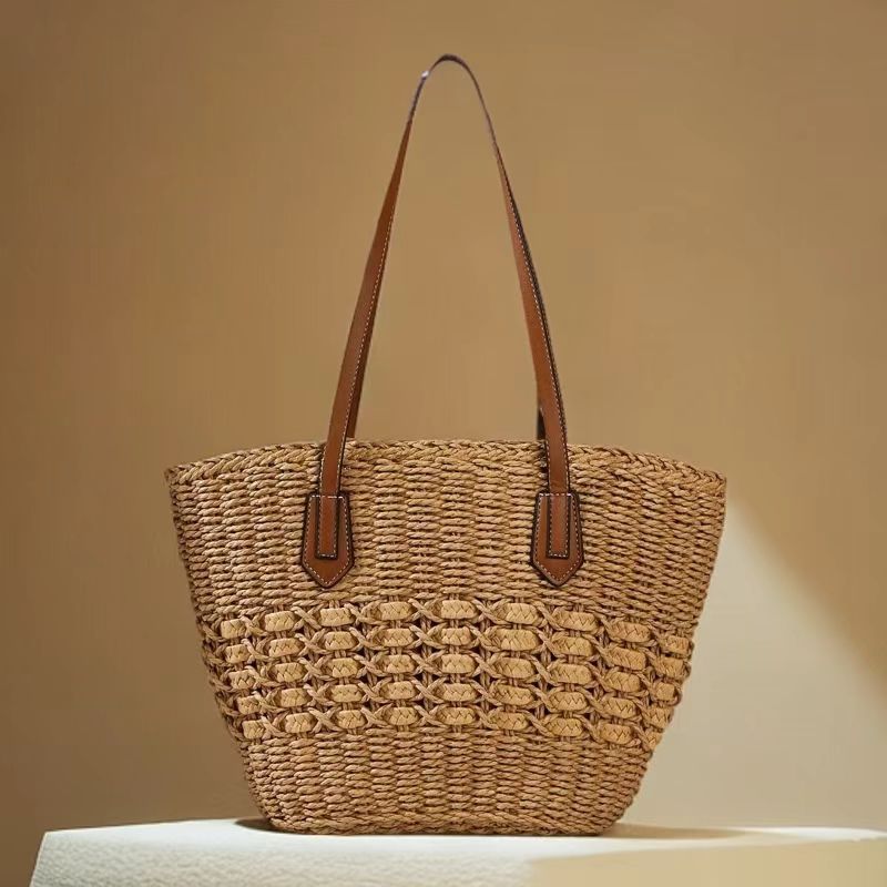 Brown woven straw shoulder tote with leather straps, natural texture in soft studio light, by Solmerea.