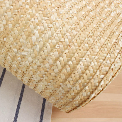 Macro close-up of straw weaving texture showing natural pattern and smooth surface finish.