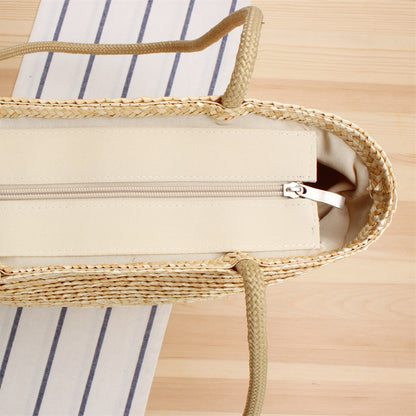 Top view of straw beach tote bag showing zippered fabric lining and neat interior finish.