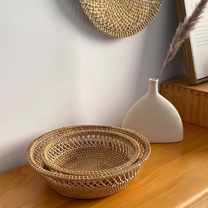 Stacked Sturdy Rattan Fruit Trays styled on wooden console beside ceramic vase.