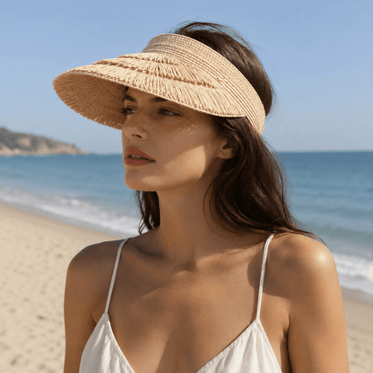 Woman wearing a wide brim straw sun visor with layered fringe detail at the beach